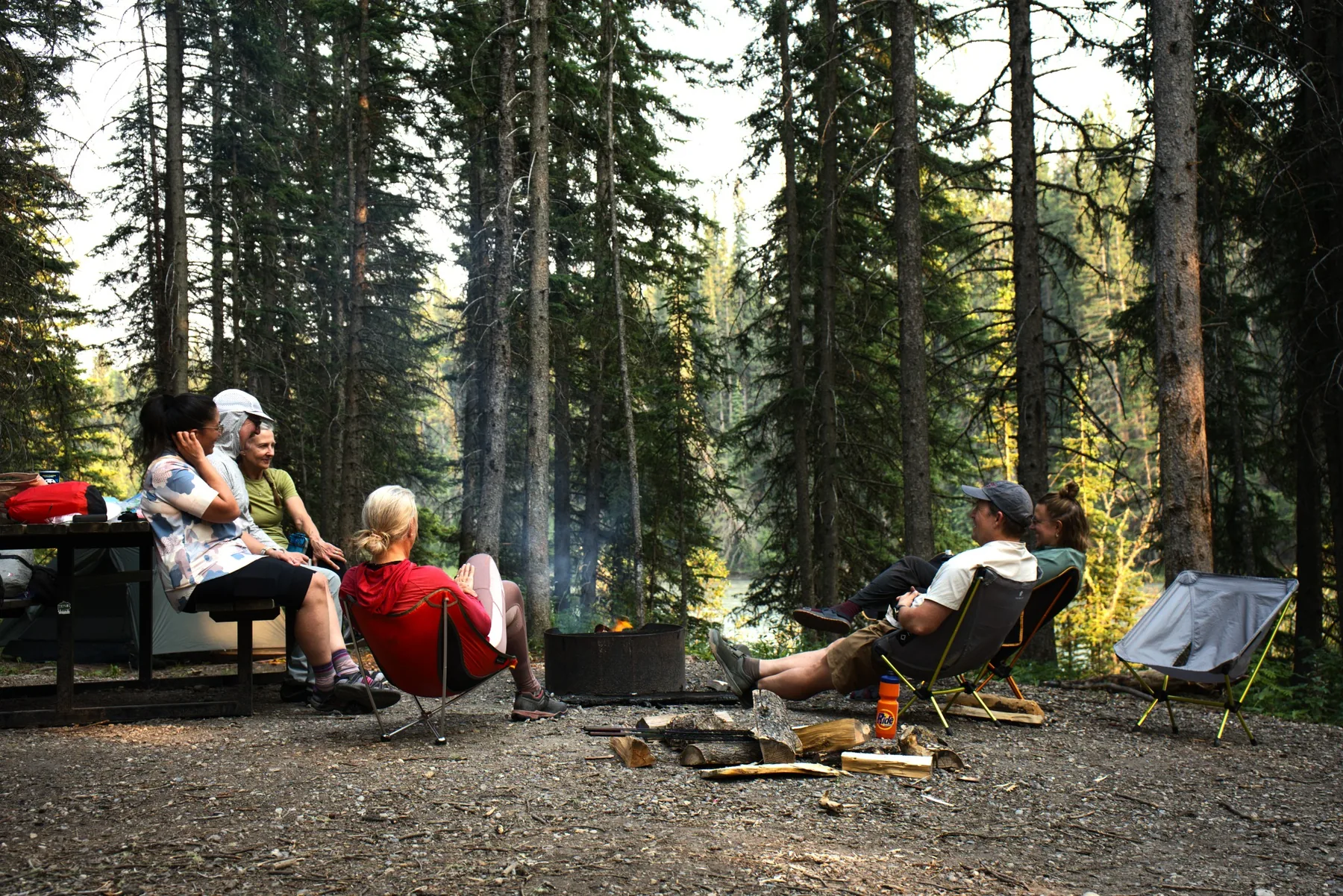 Bikepackers sitting around a campsite fire