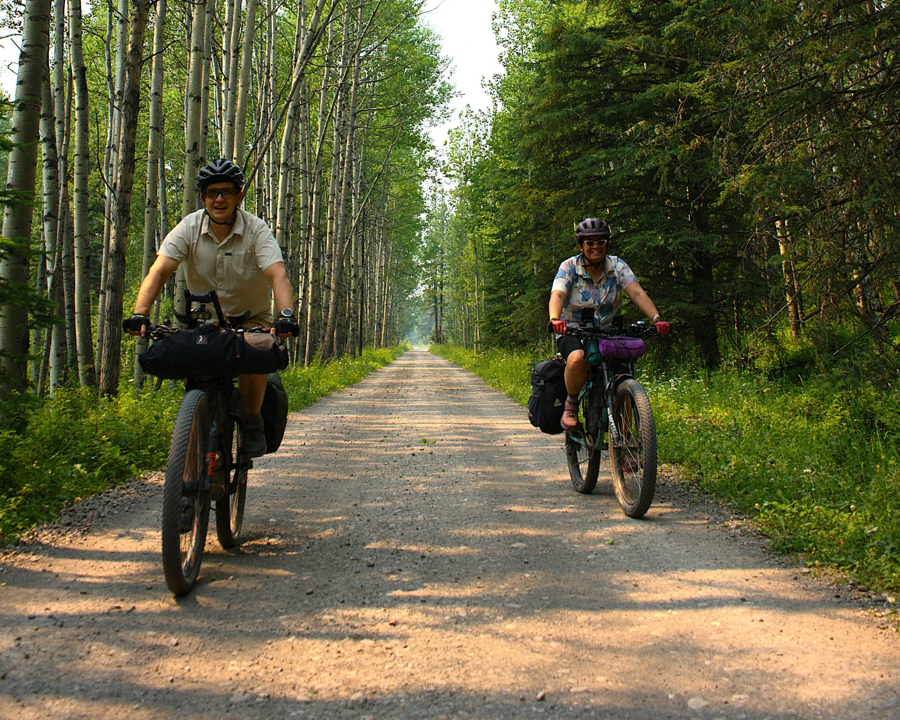 Bikepackers riding together on a forest road